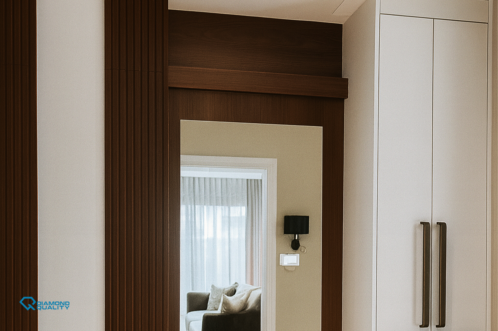 Custom white wardrobe with warm wood framing – High End Apartment Renovation Sharjah