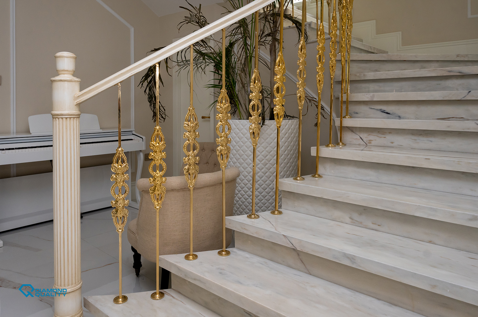 Elegant marble staircase with ornate gold railing design in a classic modern villa renovation Dubai by Diamond Quality.