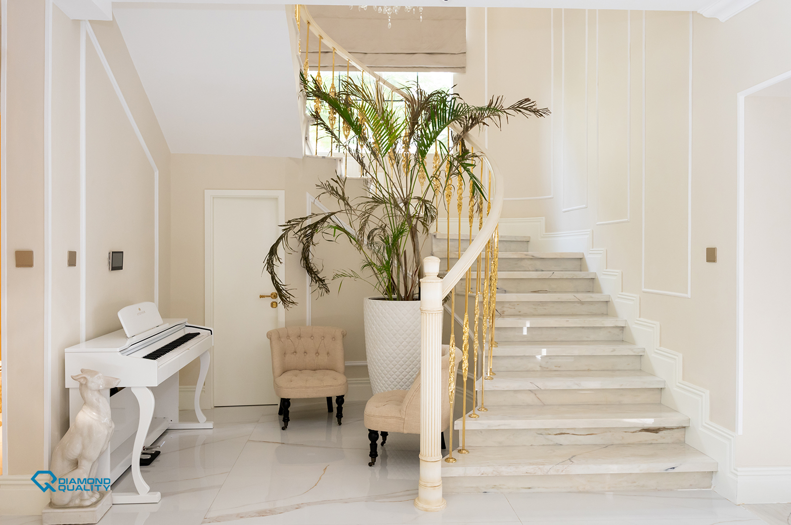 Luxury staircase with marble steps, gold handrails, and a white piano — classic modern villa renovation Dubai.