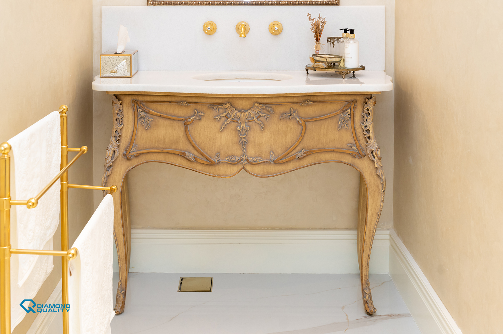 Classic vanity unit with carved wood and marble top in luxury villa renovation Dubai.