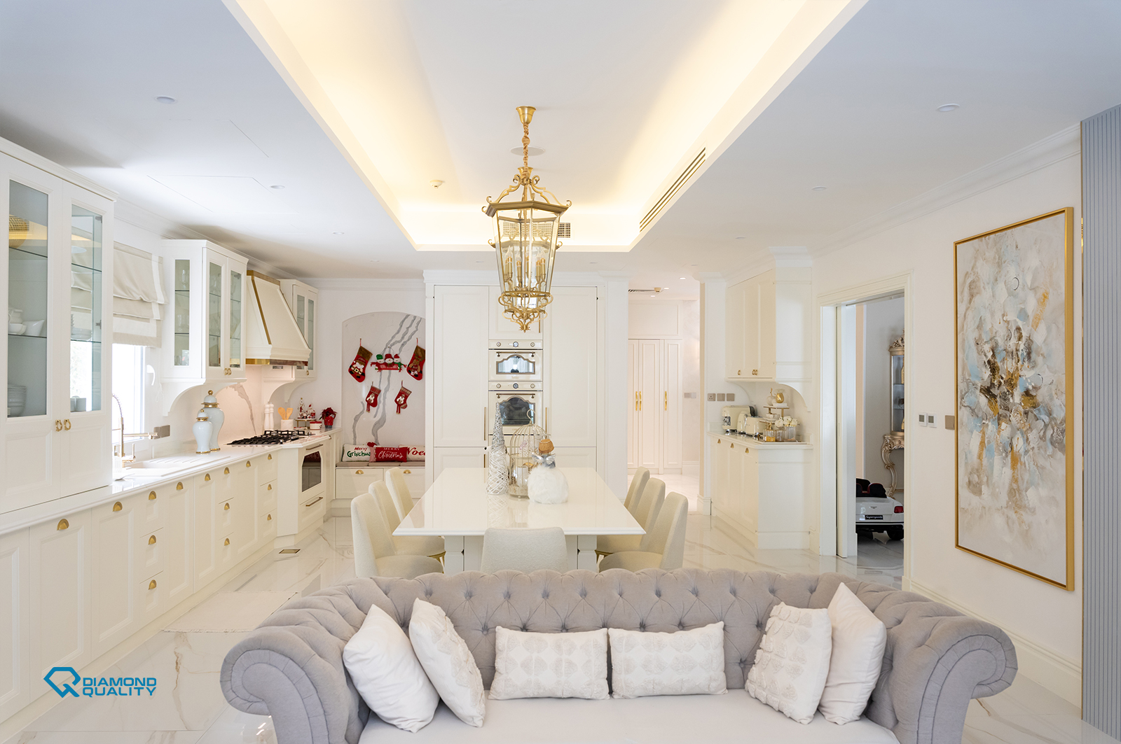Elegant living and kitchen area with classic modern design and gold detailing in Dubai.